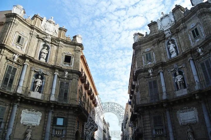 Two symmetrical, highly decorated historical facades facing each other outdoors.